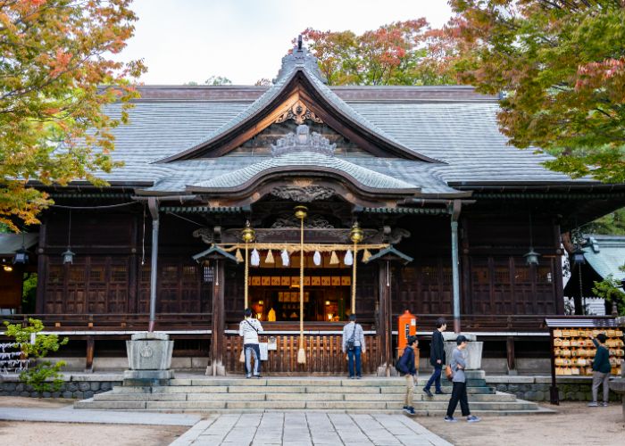 People pray at the main shrine of Yohashira Shrine in Matsumoto